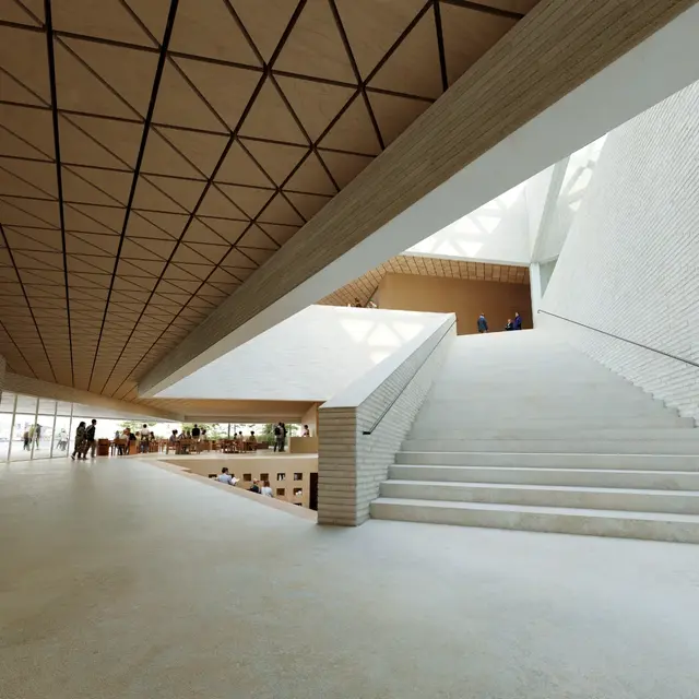 Havainnekuva sisätilasta, josta nousee leveät portaat