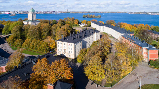 Aerial photo of an island with a church tower and residential buildings.