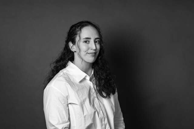 Portrait photo of a smiling woman.