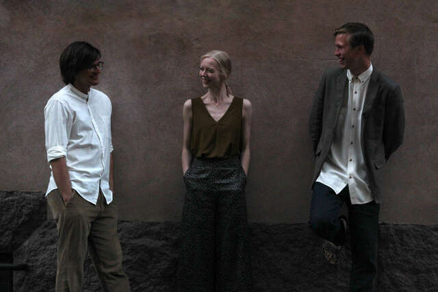 Photo of three smiling people.