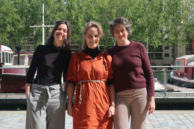Three women are looking at the camera