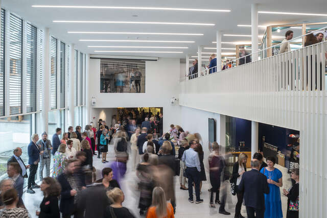 Group of people in a large museum space.
