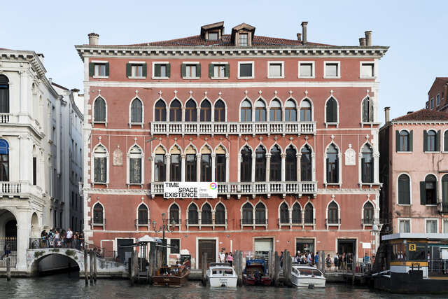 A large stone house in Venice, on the banks of a river.