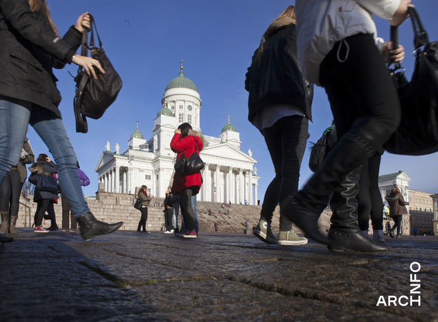 Maanrajasta otettu kuva kohti Tuomiokirkkoa, etualalla kävelevien ihmisten jalkoja