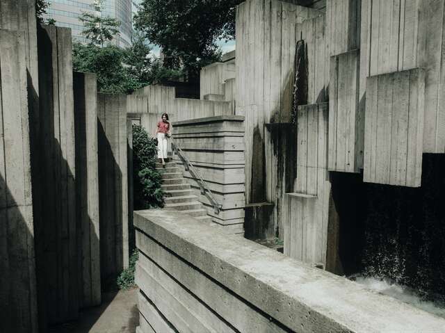 A woman in the middle of a concrete structure.