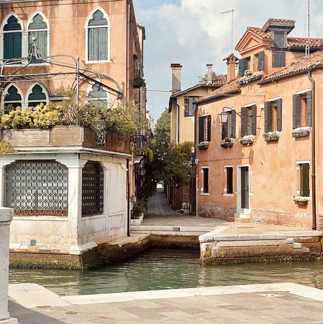 Old buildings with a canal flowing in the middle.